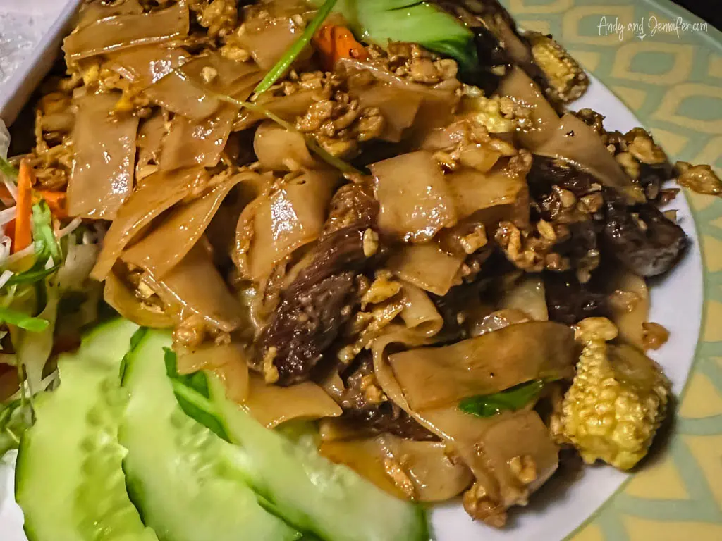 Close-up of a flavorful plate of Pad See Ew, a popular Thai noodle dish. 
