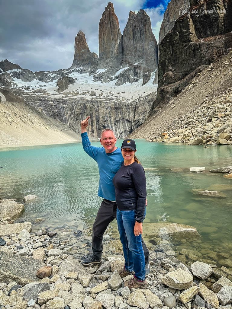 Couple celebrating by turquoise lake with towering granite peaks