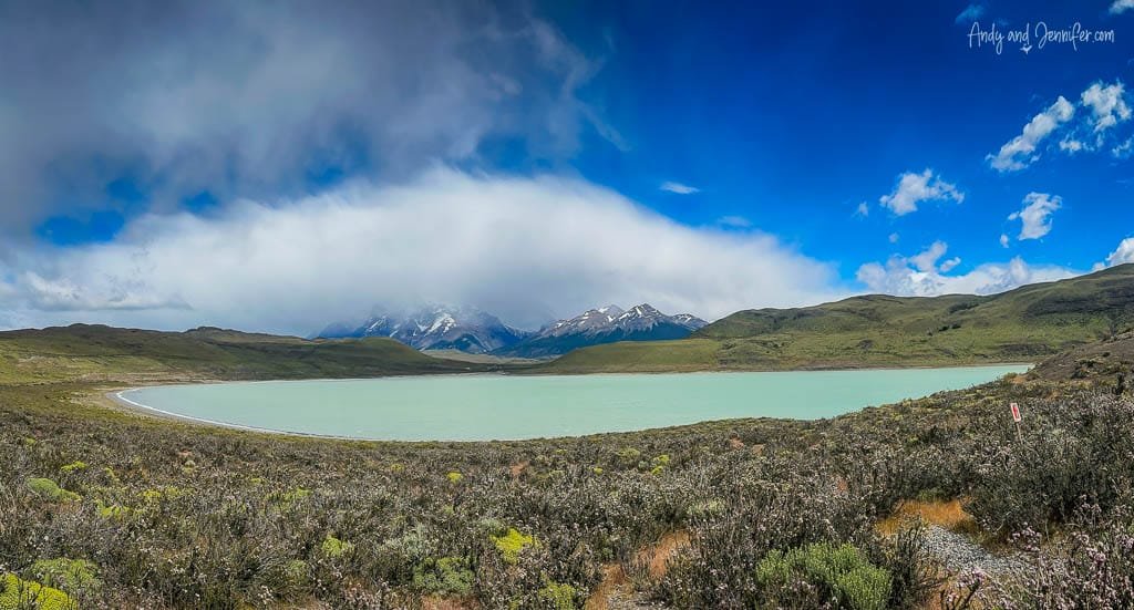Small glacial lake in front of shrouded mountains