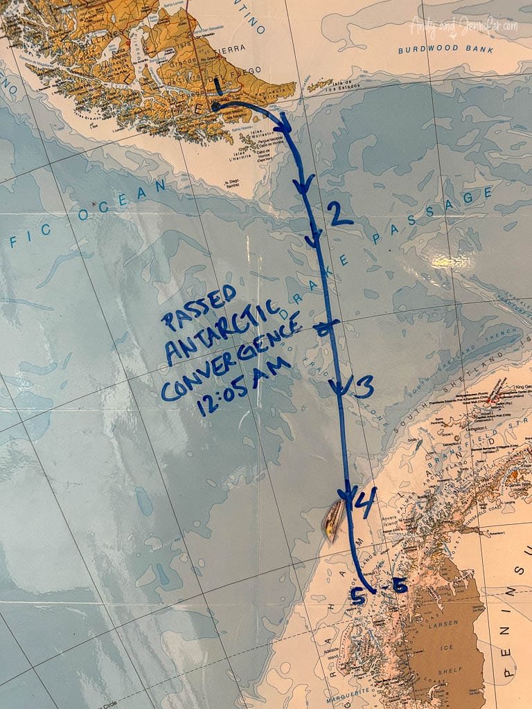 Map showing a marked route across the Drake Passage from South America to the Antarctic Peninsula, with handwritten notes indicating progress, including passing the Antarctic Convergence at 12:05 AM.