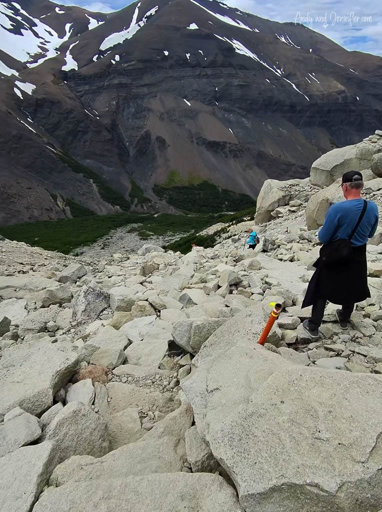 Hikers on a rocky mountain trail with steep slopes