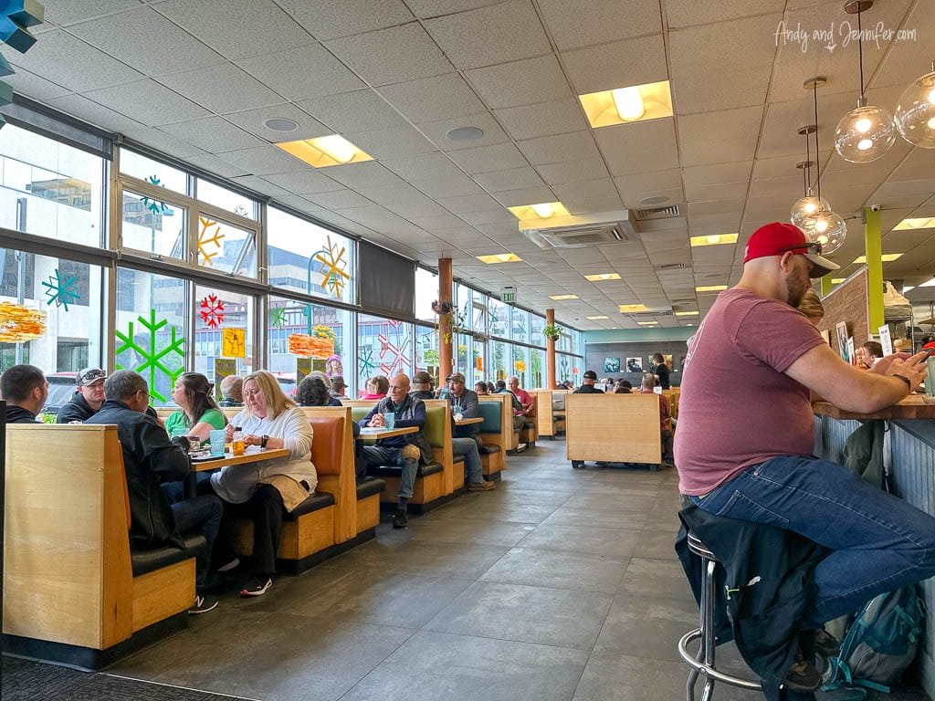 Busy diner with people seated at booths and counter stools