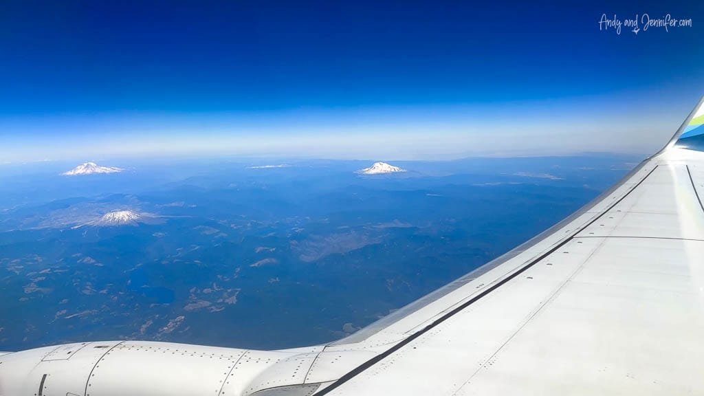 View of snowy mountain peaks from airplane window