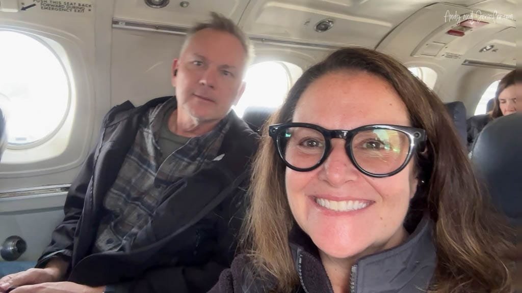 Smiling passengers taking a selfie inside a small airplane