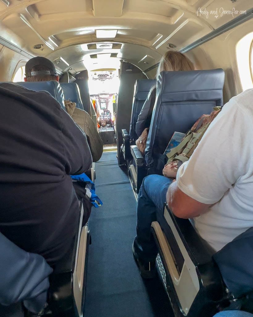 Passengers seated inside a small airplane cabin