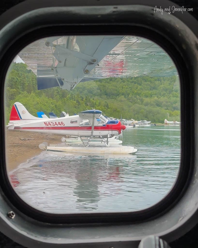 View of seaplanes on a beach through a plane window