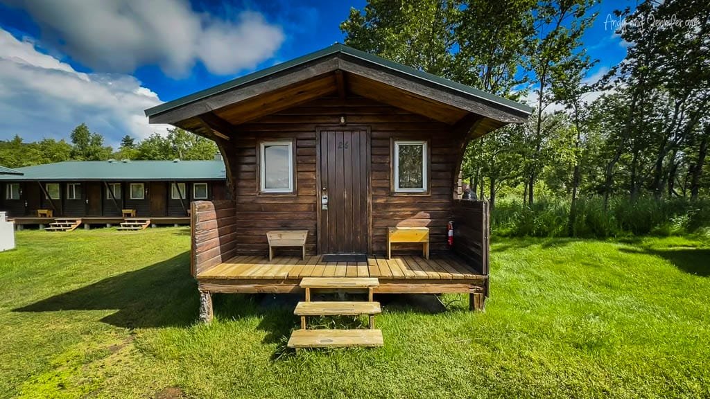 Wooden cabin with porch in a grassy campground