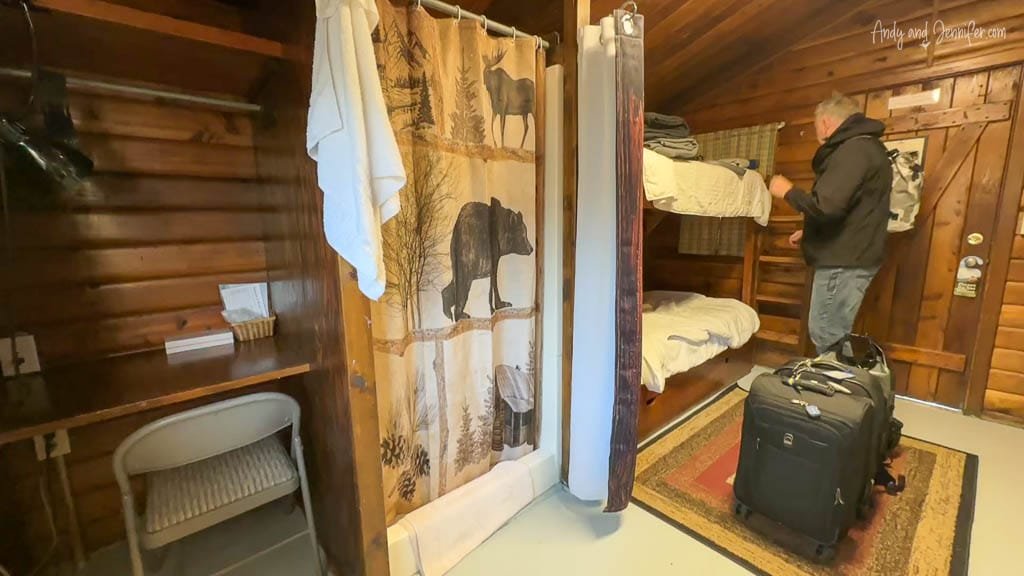 Cozy cabin interior with bunk beds and wildlife-themed shower curtain