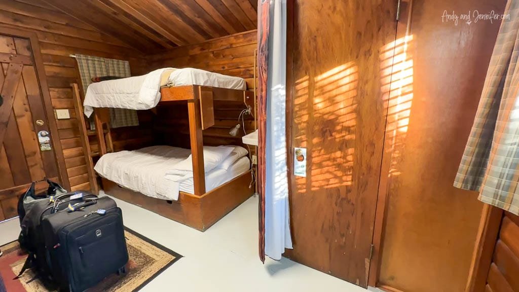 Wooden cabin with bunk beds and luggage on the floor