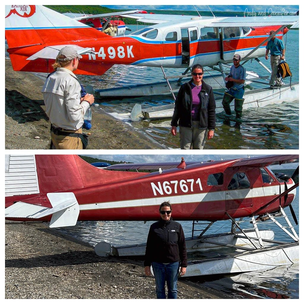 Two floatplanes on shore with passengers posing beside them