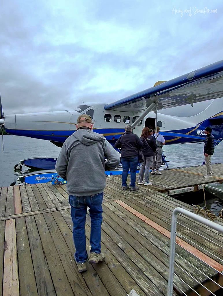 People boarding a seaplane from a wooden dock