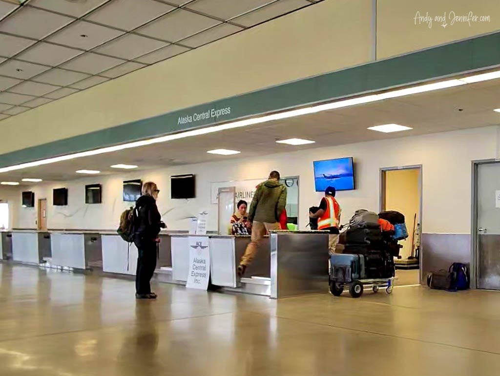 Travelers being weighed at Alaska Central Express check-in counter