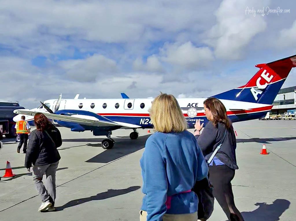 Passengers walking toward Alaska Central Express plane on tarmac