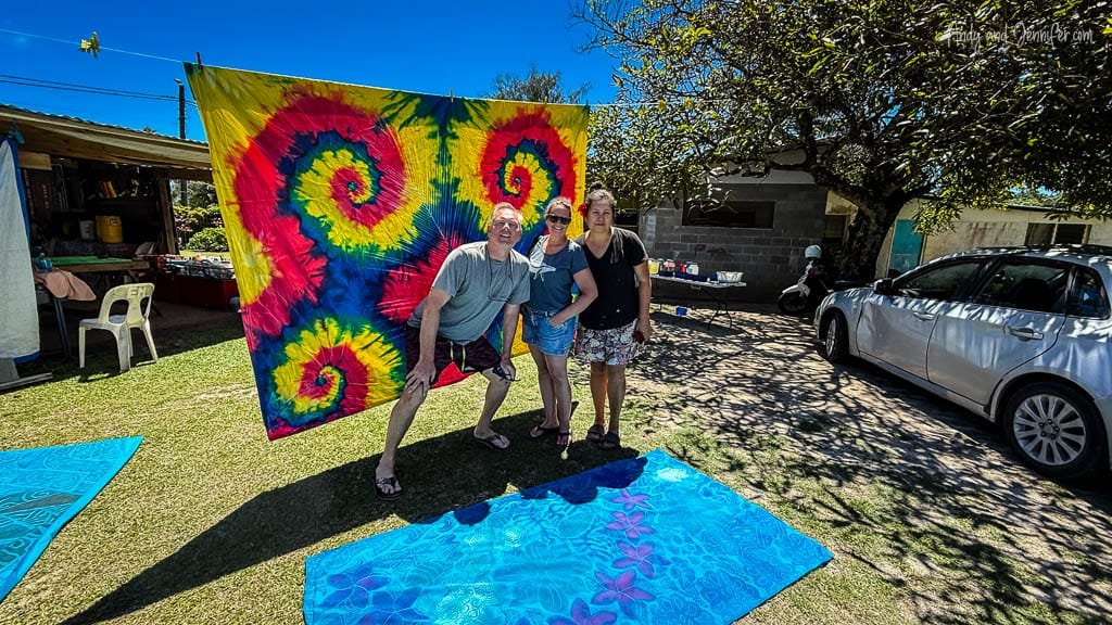 A vibrant tie-dye creation hanging to dry with proud participants at the Tie Dye Rarotonga workshop.
