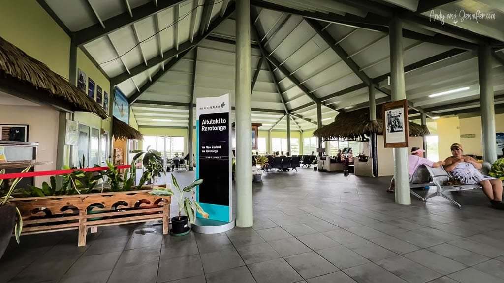 Aitutaki Airport's open-air terminal with relaxed seating and tropical decor, providing a laid-back departure experience.