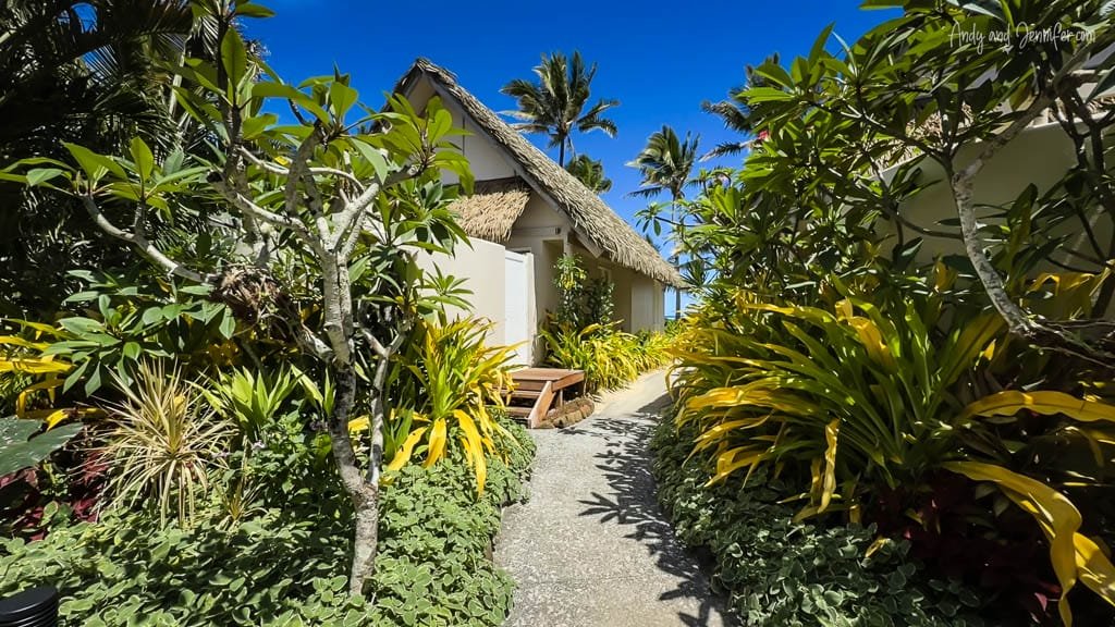Lush tropical pathway leading to a private bungalow at the Little Polynesian Resort.