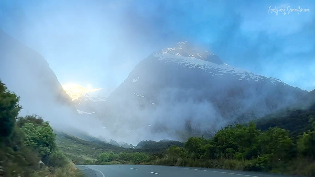 Snow-capped mountain partially covered in fog