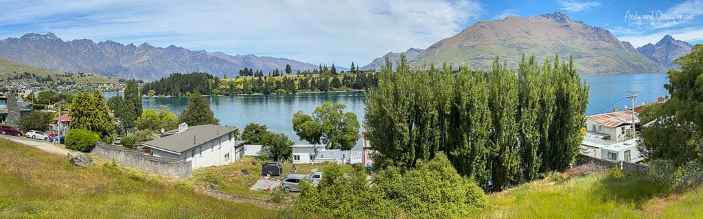 Panoramic view of Queenstown with lake and mountain range.