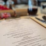 Holiday dinner menu on elegant table setting