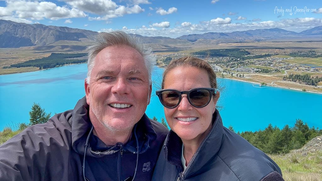 Couple selfie overlooking bright blue Lake Tekapo