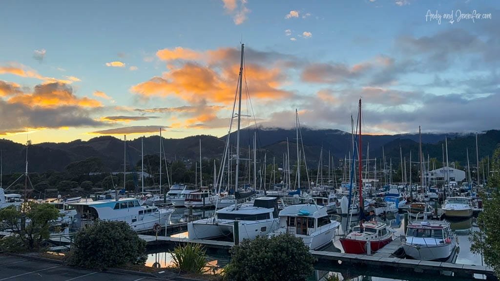 Marina with docked boats at sunset and mountains