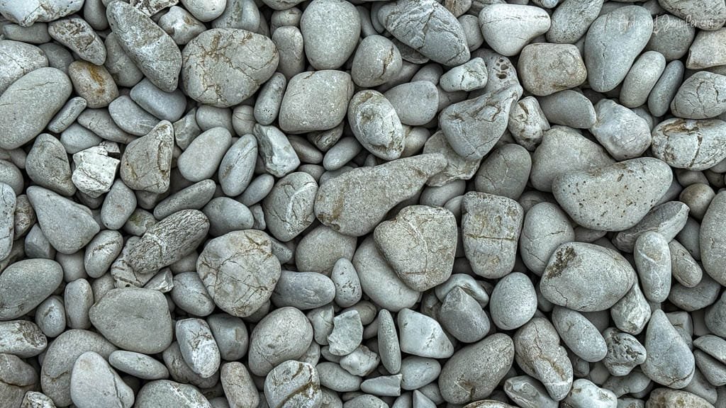 Smooth gray pebbles in a natural stone texture.