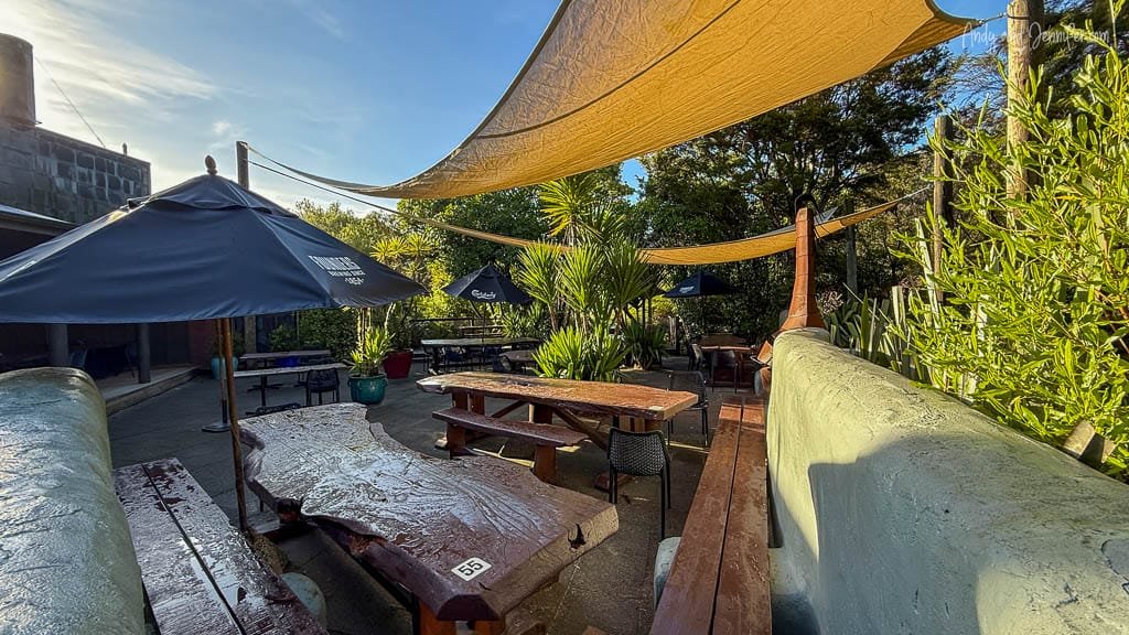 Outdoor patio seating with umbrellas and shade sails