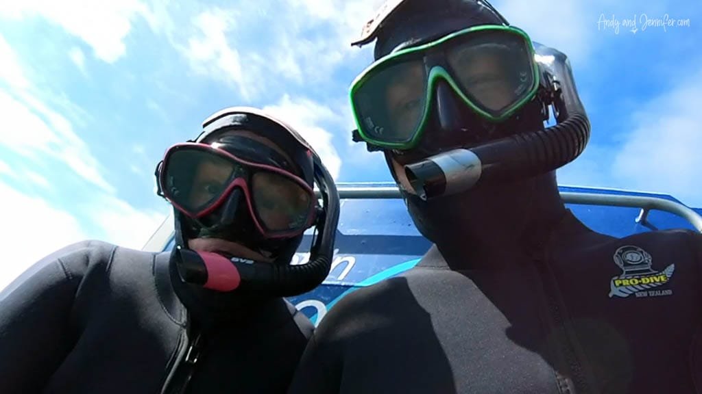 Two snorkelers in wetsuits on dive boat