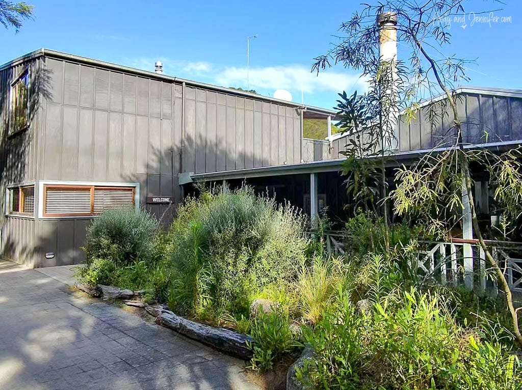 Modern lodge exterior with lush native landscaping