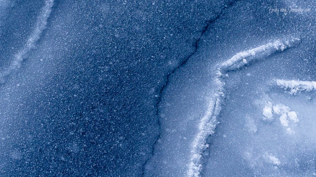 Close-up of frosted blue ice with surface cracks