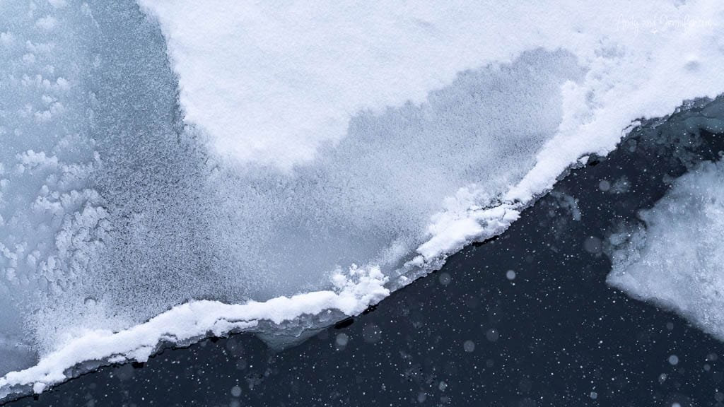Thin snow-covered ice edge over dark polar wate