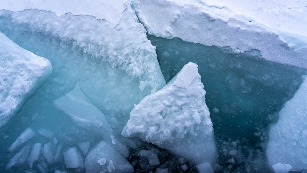 Jagged broken ice slabs in turquoise Arctic water