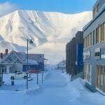 Snowy Longyearbyen street with Arctic mountain backdrop