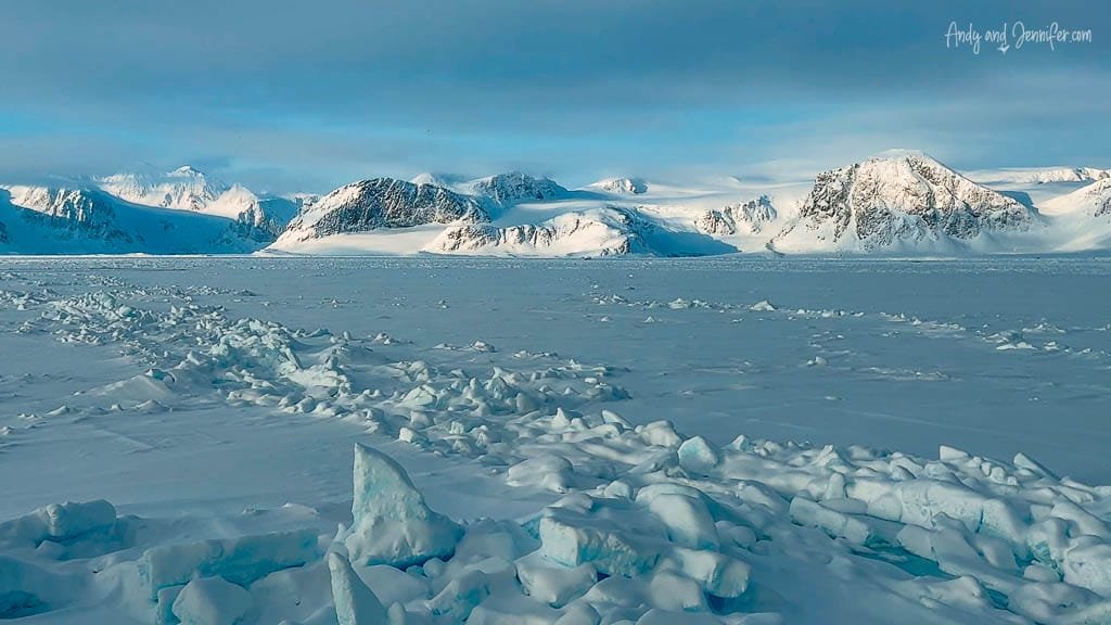 Icy Arctic plain with mountain backdrop
