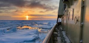 Arctic ice floes at sunset beside ship walkway