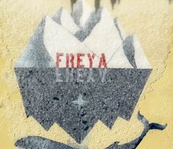 Icicles above a painted whale and iceberg logo reading "FREYA".