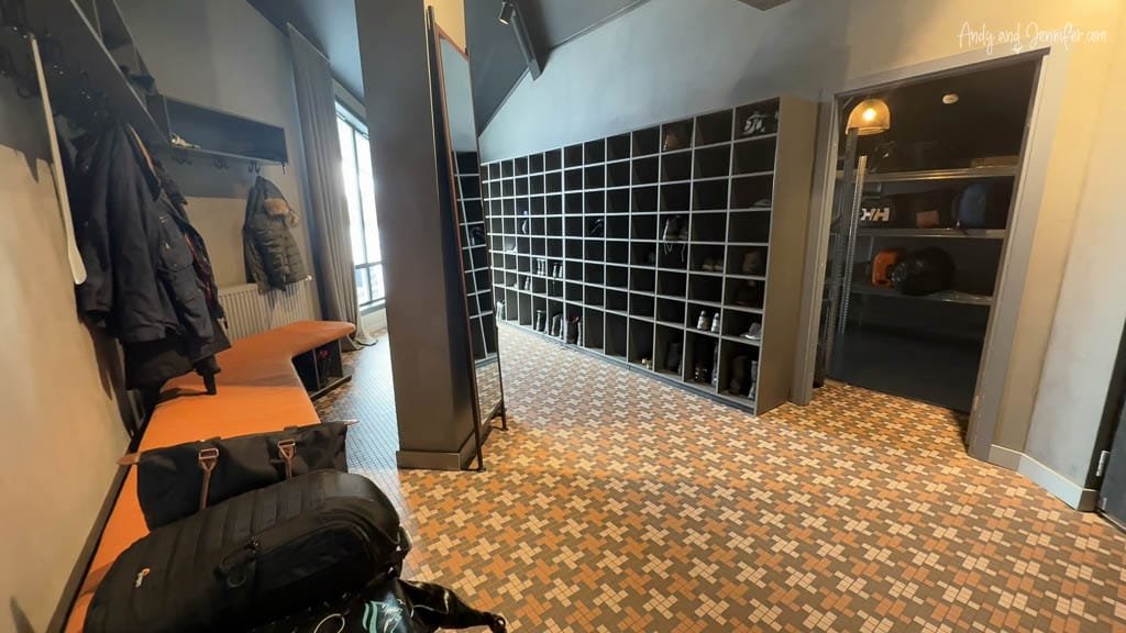 Modern arctic gear room with benches, hanging coats, and cubby lockers.