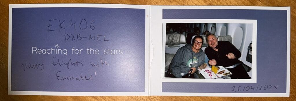 Souvenir photo of two smiling passengers from Emirates flight 406 