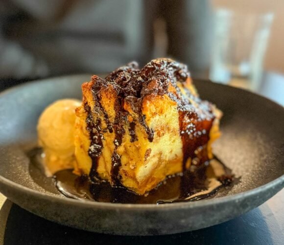 Bread pudding with chocolate drizzle and ice cream