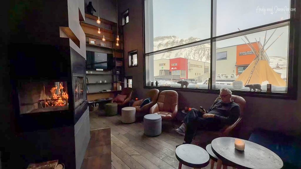 Cozy hotel lounge with fireplace and snowy mountain view