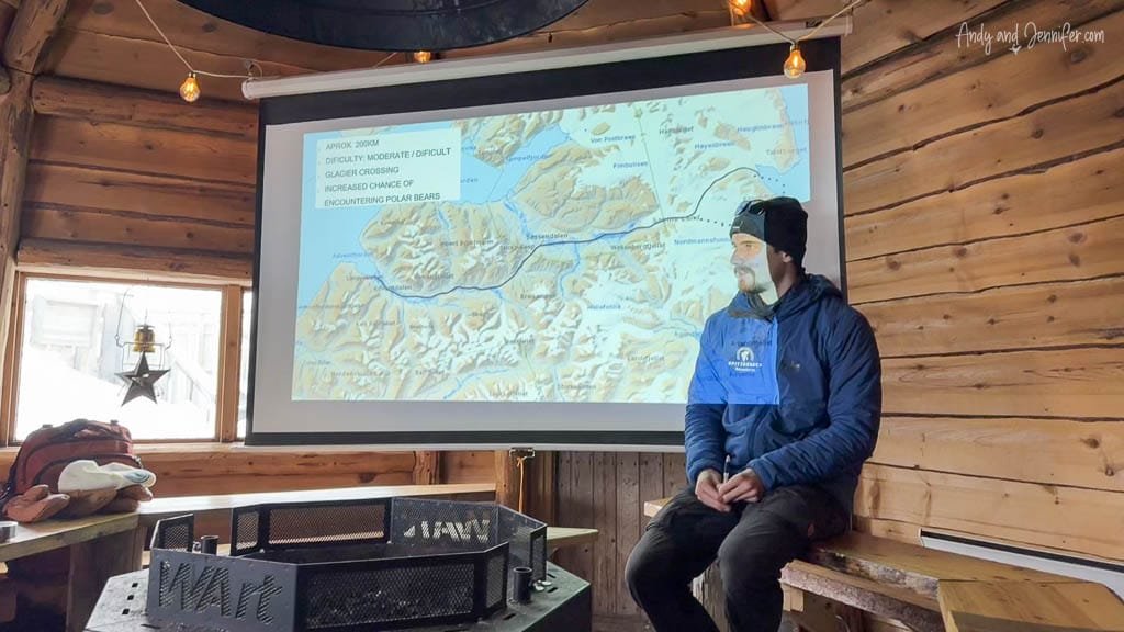 Guide briefing with polar route map of snowmobile trip to East Svalbard