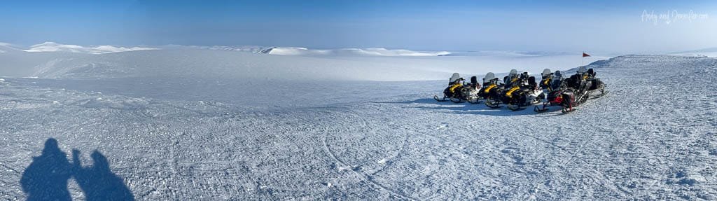Snowmobiles on vast Arctic snowfield during snowmobile trip to East Svalbard
