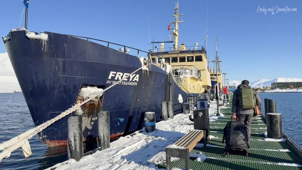 Traveler boarding Freya ship at snowy Arctic dock ready for a Svalbard photography expedition