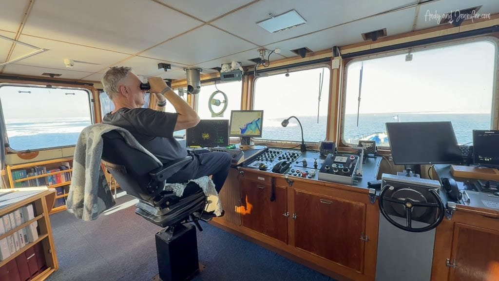 Man using binoculars in Arctic ship bridge