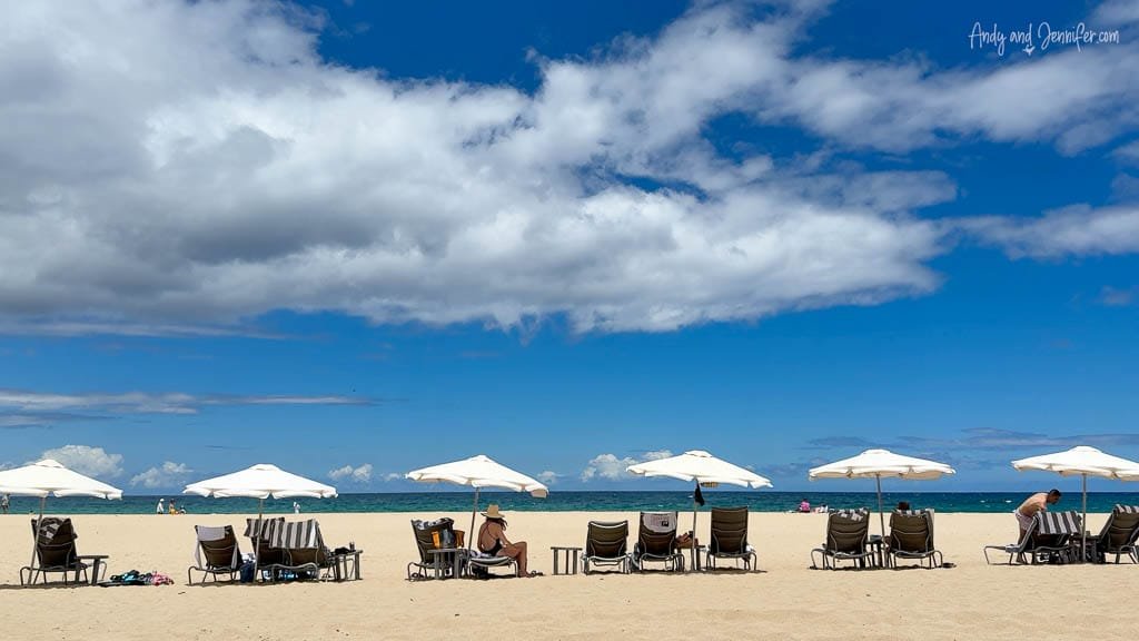 Beach chairs and umbrellas on sunny tropical beach