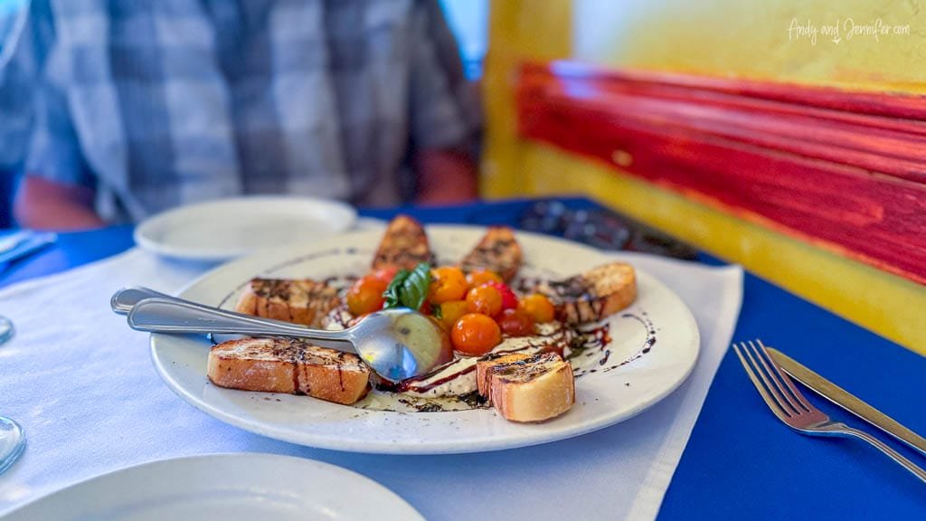 Bruschetta with whipped fetta and cherry tomatoes on restaurant plate