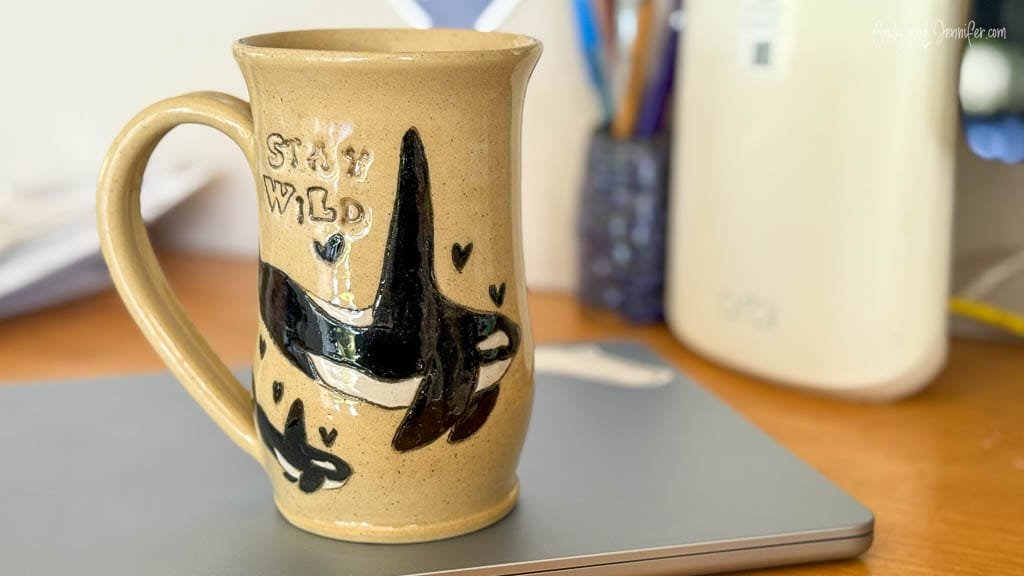 Handmade mug with orcas and "Stay Wild" text