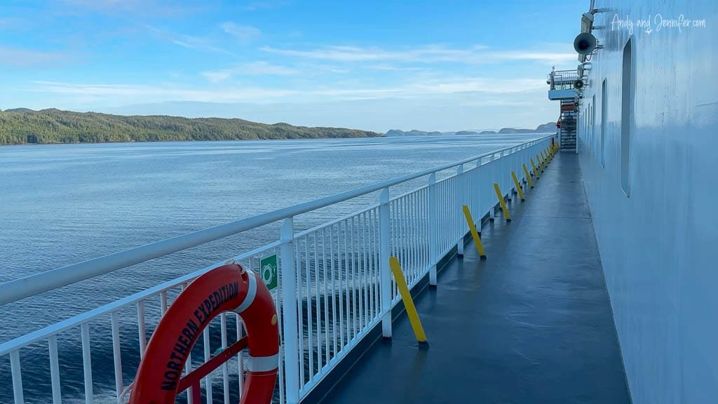 View along the deck of the Northern Expedition ferry with ocean and islands in background.