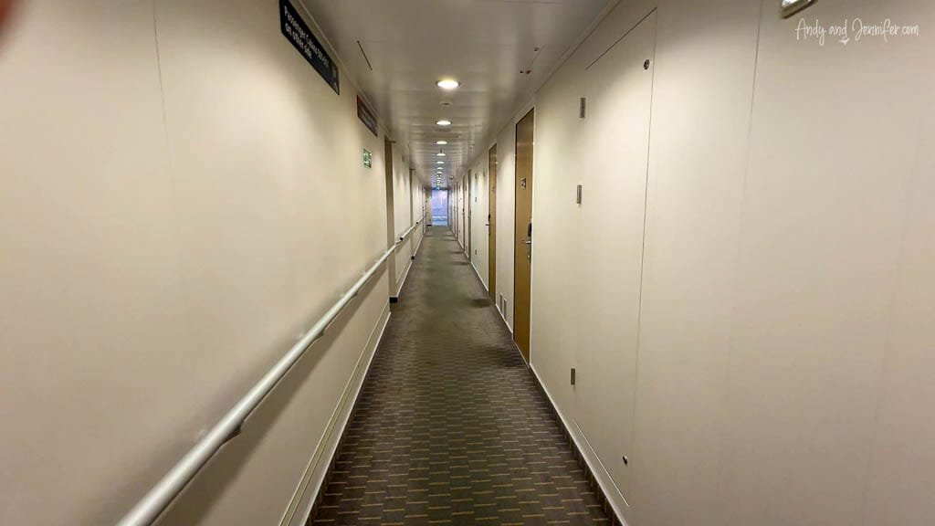 Long hallway inside passenger ferry with cabin doors.