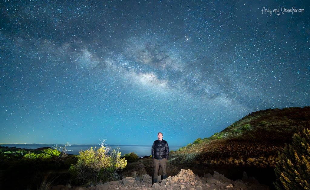 Man standing under bright Milky Way sky